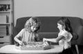 Cute little boy and girl eating Pizza at home. Children holding a slices of pizza on party at home. Children sharing a Royalty Free Stock Photo