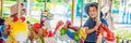 Cute little boy and girl enjoying in funfair and riding on colorful carousel house BANNER, long format Royalty Free Stock Photo