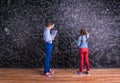 Cute little boy and girl in front of a big blackboard. Royalty Free Stock Photo