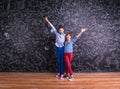 Cute little boy and girl in front of a big blackboard. Royalty Free Stock Photo