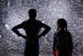 Cute little boy and girl in front of a big blackboard. Royalty Free Stock Photo