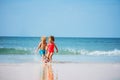 Cute little boy and a girl play ball in the ocean waves Royalty Free Stock Photo