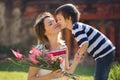 Cute little boy, giving present to his mom for Mothers day Royalty Free Stock Photo
