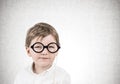 Cute little boy with glasses, concrete Royalty Free Stock Photo