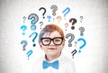 Cute little boy in glasses, question marks Royalty Free Stock Photo