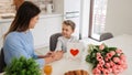 Cute little boy greeting his mother at home. Mother's day concept. Happy mother's day! Royalty Free Stock Photo