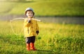 Cute little boy in hat holding big fishing net at the ready Royalty Free Stock Photo