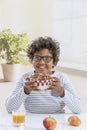 Cute little boy having breakfast at home drinking a large bowl of milk in grey T-shirt Royalty Free Stock Photo