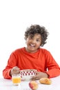 Cute little boy having breakfast at home drinking a large bowl of milk in red T-shirt Royalty Free Stock Photo