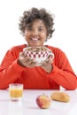 Cute little boy having breakfast at home drinking a large bowl of milk in red T-shirt Royalty Free Stock Photo