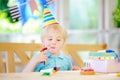 Cute little boy having fun and celebrate birthday party with colorful decoration and cake Royalty Free Stock Photo