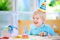 Cute little boy having fun and celebrate birthday party with colorful decoration and cake Royalty Free Stock Photo