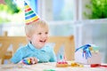 Cute little boy having fun and celebrate birthday party with colorful decoration and cake Royalty Free Stock Photo