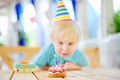 Cute little boy having fun and celebrate birthday party with colorful decoration and cake Royalty Free Stock Photo