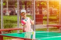 Cute little boy having fun playing table tennis in park sport ground