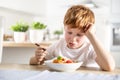 A cute little boy is having lunch but he doesn't like spaghetti Royalty Free Stock Photo