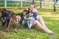 Cute little boy with his mom feeding goat in farm Royalty Free Stock Photo