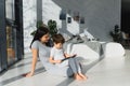 Cute little boy and his young mother using a digital tablet and smiling on the floor at home. Happy family with gadget Royalty Free Stock Photo