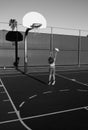 Cute little boy holding a basket ball trying make a score. Sport for kids.