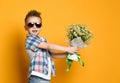 Cute little boy holding a bouquet of flowers. Royalty Free Stock Photo