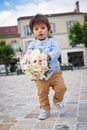 Cute little boy holding a bouquet of flowers