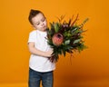 Cute little boy holding a bouquet of flowers. Royalty Free Stock Photo