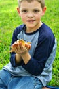 Cute little boy holding frog