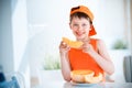 Cute little boy holding sliced orange cantaloupe melon in hands Royalty Free Stock Photo