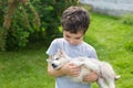 Cute little boy holds on a hands a sleeping husky puppy