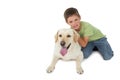 Cute little boy kneeling with his labrador smiling at camera
