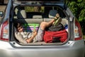 Cute little boy laying on the back of the bags and baggage in the car trunk ready to go on vacation with happy Royalty Free Stock Photo