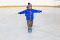 Cute little boy learning to skate in winter Royalty Free Stock Photo