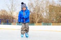 Cute little boy learning to skate in winter Royalty Free Stock Photo