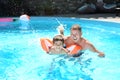 Cute little boy learning to swim with father in pool Royalty Free Stock Photo