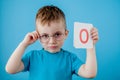 Cute little boy with letter on blue background. Child learning a letters. Alphabet Royalty Free Stock Photo