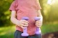 Cute little boy lifting dumbbells outdoors Royalty Free Stock Photo