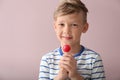 Cute little boy with lollipop on color background Royalty Free Stock Photo