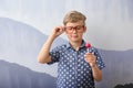 Cute little boy with lollipop near grey wall Royalty Free Stock Photo