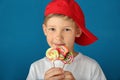 Cute little boy with lollipops on color background Royalty Free Stock Photo