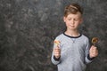 Cute little boy with lollipops on grey background Royalty Free Stock Photo