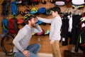 cute little boy looking at happy father wearing bicycle helmet