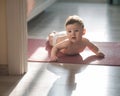 Cute little boy lying on his forearms on the floor. Royalty Free Stock Photo