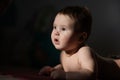 Cute little boy lying on his forearms on the floor. Royalty Free Stock Photo