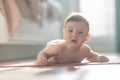 Cute little boy lying on his forearms on the floor. Royalty Free Stock Photo