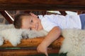 Cute little boy lying on wooden bench Royalty Free Stock Photo