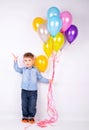 Cute little boy with multi-colored balloons in hands Royalty Free Stock Photo