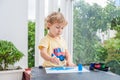 Cute little boy painting with colorful paints Royalty Free Stock Photo