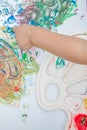 Cute little boy painting with a paint hands using gauche paints Royalty Free Stock Photo