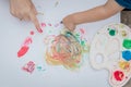 Cute little boy painting with a paint hands using gauche paints Royalty Free Stock Photo