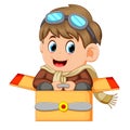 Cute little boy in pilot costume and glasess playing with airplane toys